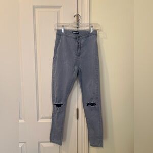 MOMOKROM Gray high-waisted distressed skinny jeans w/ knee holes.